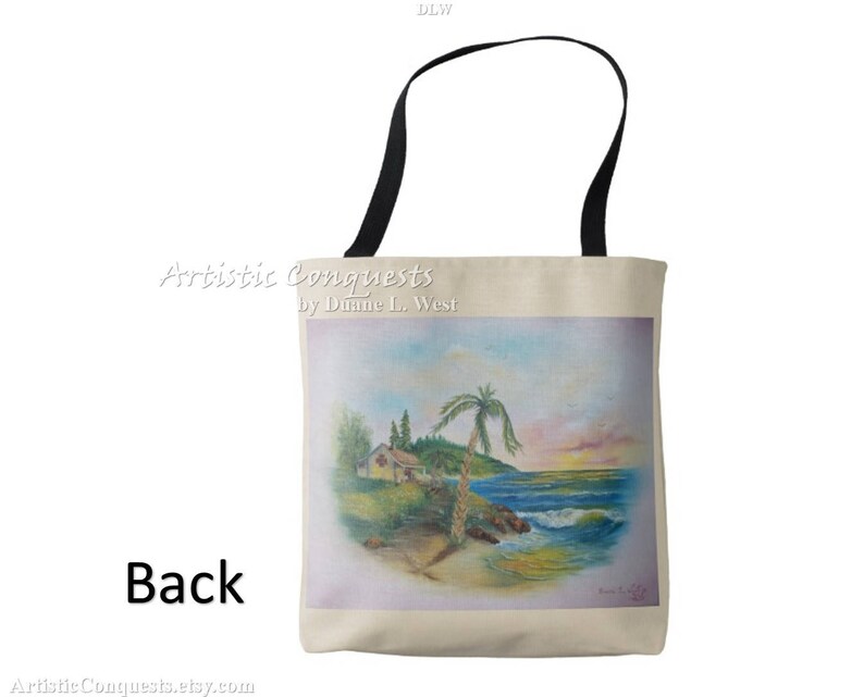May include: A beige tote bag with black handles. The bag features a painting of a beach scene with a small house, palm trees, and ocean waves. The text "Artistic Conquests by Dianne L. West" is printed on the bag.