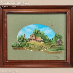 May include: A framed painting of a rustic farmhouse with a green roof and a wooden fence. The house is surrounded by trees and a blue sky with white clouds. The painting is signed "Duane L. West" in the bottom right corner.