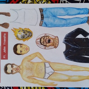 May include: A paper doll set featuring Nicolas Cage and John Travolta. The set includes a variety of outfits and accessories, including a white tank top, blue jeans, a black leather jacket, and a skull mask. The paper doll set is printed on white paper with red and black text.