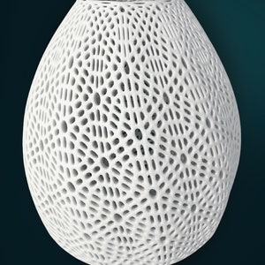 May include: White ceramic vase with a geometric, openwork design. The vase is approximately 23 inches in diameter and 26 inches tall.