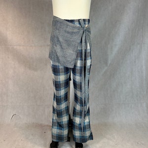 May include: A pair of blue and white plaid pants with a gray wrap skirt tied around the waist.