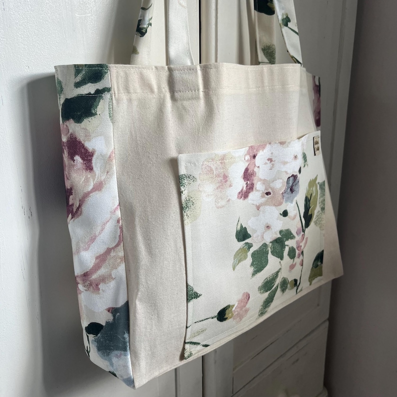Handmade Tote bag made with canvas and the sides, handles and front pocket are made with a hydrangea flower printed fabric.