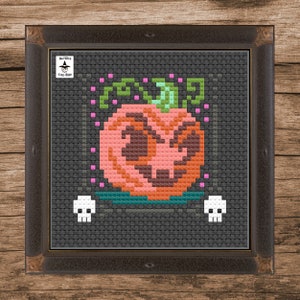 May include: Cross stitch pattern of a scary pumpkin with a green stem and pink accents on a black background. The pattern is titled "Bad Witch Cross Stitch".