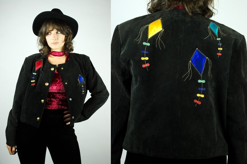 May include: A black suede jacket with colourful kite embroidery on the back. The kites are yellow, blue, and red with gold thread accents.