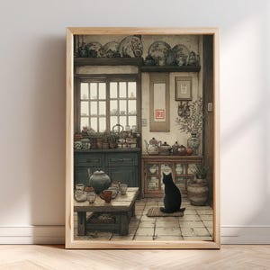 May include: A framed wall art print depicting a kitchen interior with a black cat sitting on a tiled floor. The scene features wooden cabinets, shelves filled with ceramic teapots and plates, a low wooden table with tea cups, and a hanging scroll with red Japanese calligraphy characters.