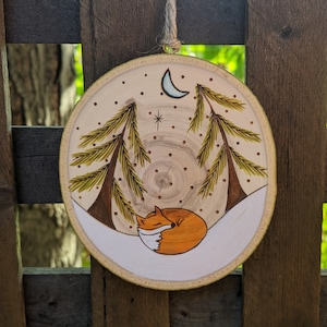Wood burned sleepy fox and evergreens ornament