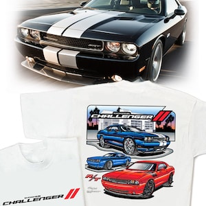 May include: White t-shirt with a graphic design of three Dodge Challenger cars. The cars are blue, red, and black. The text "Dodge Challenger" is printed on the shirt.