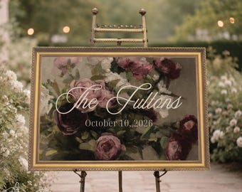 Op de afbeelding: Een rechthoekig bord in een sierlijke gouden lijst op een metalen ezel. Het bord heeft een donkere bloemenprint met donkerrode en roze rozen. Witte cursieve tekst leest The Fultons en de datum 10 oktober 2026 staat eronder in het wit.