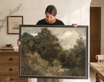 May include: A large rectangular landscape painting in a black frame with gold inner trim. The artwork depicts a moody, impressionistic scene of dense, dark green and brown trees, rolling hills, and a cloudy, overcast sky in muted earth tones.