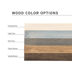 May include: Wood color options for a product. The options are: Finished Pine, Light Gray, Dark Gray, Classic Brown, and Saddle Brown.