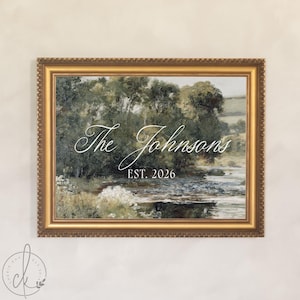 May include: A landscape painting in a decorative gold frame featuring a river flowing through trees and fields. The text "The Johnsons" is written in white cursive script above the text "EST. 2026" in a clean, white, sans-serif font.