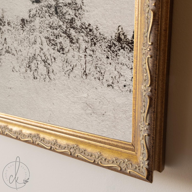 May include: A framed artwork with a gold ornate frame. The artwork features a black and white abstract landscape. The frame has a detailed, vintage design. The artwork is mounted on a light-colored wall.