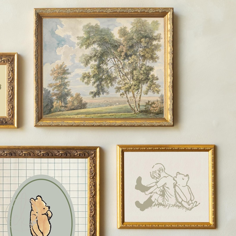 May include: A collection of framed art pieces. One frame contains a landscape painting with trees and a cloudy sky. Other frames feature illustrations of a bear and a child. The frames have ornate gold-coloured borders.