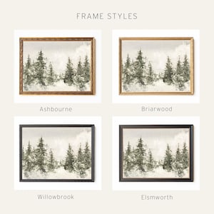 May include: Four framed landscape prints labeled FRAME STYLES. Each print depicts a winter forest scene with evergreen trees in muted green and white tones. The frames are labeled Ashbourne, Briarwood, Willowbrook, and Elsworth, showing different textures and colors including dark wood, light wood, and black finishes.