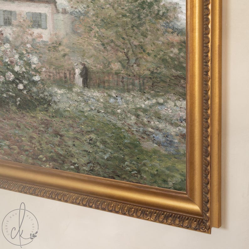 May include: A framed landscape painting with a gold ornate frame. The artwork depicts a garden scene with a house, trees, and figures. The painting has a soft, impressionistic style with a focus on natural light and colour.