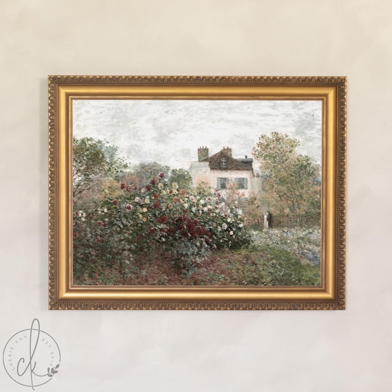 May include: A framed landscape painting depicting a house amidst vibrant flowers and foliage. The artwork is presented in a gold ornate frame, with a soft, muted colour palette, creating a vintage feel.