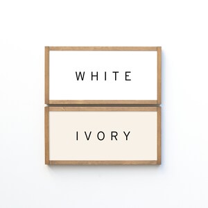 May include: Two wooden framed signs, one white with the word "WHITE" and one ivory with the word "IVORY".