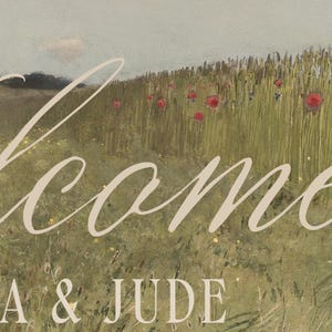 May include: A landscape painting featuring a field of tall green grass with scattered red poppy flowers under a muted sky. The word Welcome is written in a large, elegant, light-colored script font, and the text A & JUDE appears below it.