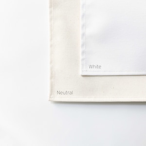 May include: Two fabric swatches, one neutral and one white, are displayed against a white background. The word "Neutral" is printed on the neutral swatch, and "White" is printed on the white swatch.