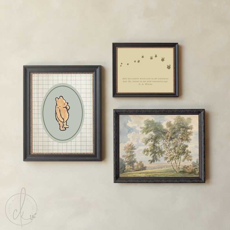May include: Three framed pictures on a wall. One features Winnie the Pooh, another has a quote, and the third is a landscape painting. The frames are black, and the art has a vintage aesthetic. The Winnie the Pooh art is in an oval shape.