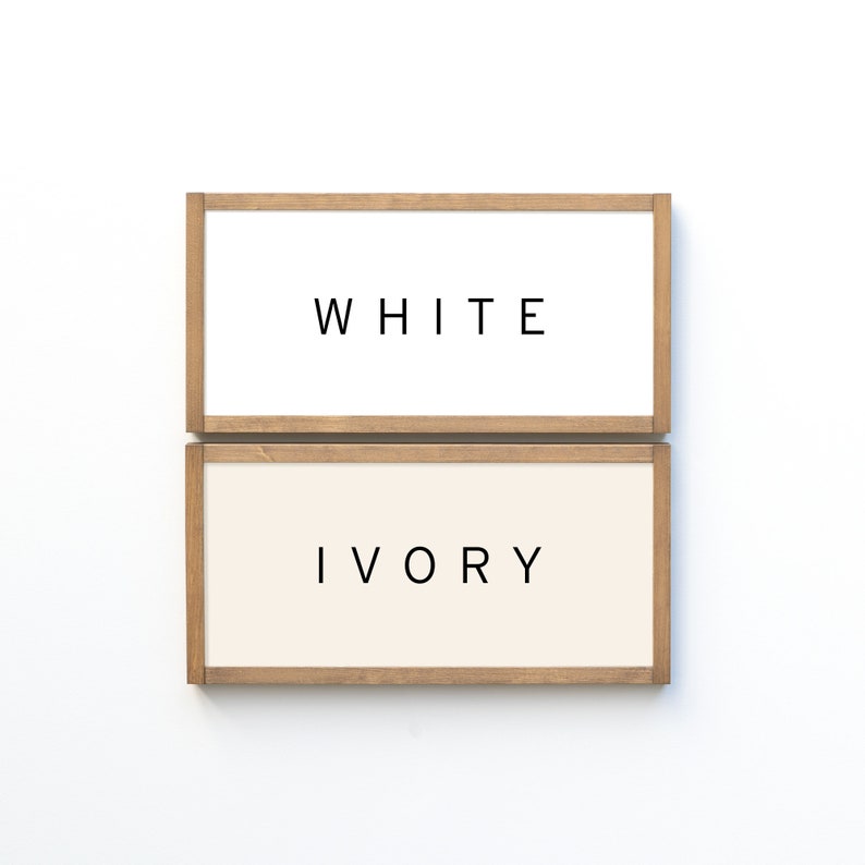 May include: Two wooden framed signs, one white with the word "WHITE" and one ivory with the word "IVORY".