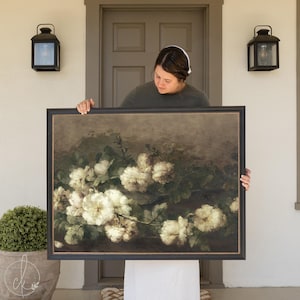May include: A framed painting of a bouquet of white roses with green leaves on a dark brown background.