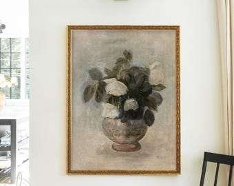 May include: A framed wall art print featuring an oil painting of a bouquet of white and dark flowers in a rounded, mottled vase. The artwork is set against a muted, textured gray and blue background, enclosed in a decorative gold frame.