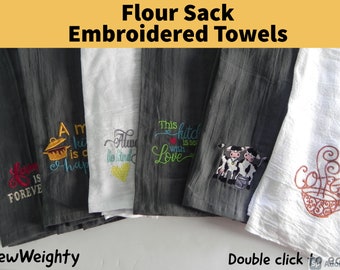 May include: Five flour sack towels with embroidered designs. The towels are in various colors, including gray and white. The designs include a pot with the text "A kitchen is a happy place", a heart with the text "Always be kind", a heart with the text "This kitchen is seasoned with love", two cows, and a coffee cup with steam.
