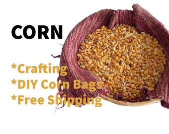 May include: A close-up of a basket filled with yellow corn kernels. The basket is lined with a red and white fabric. The text "CORN" is written in black letters above the basket. The text "*Crafting *DIY Corn Bags *Free Shipping" is written in yellow letters below the basket.