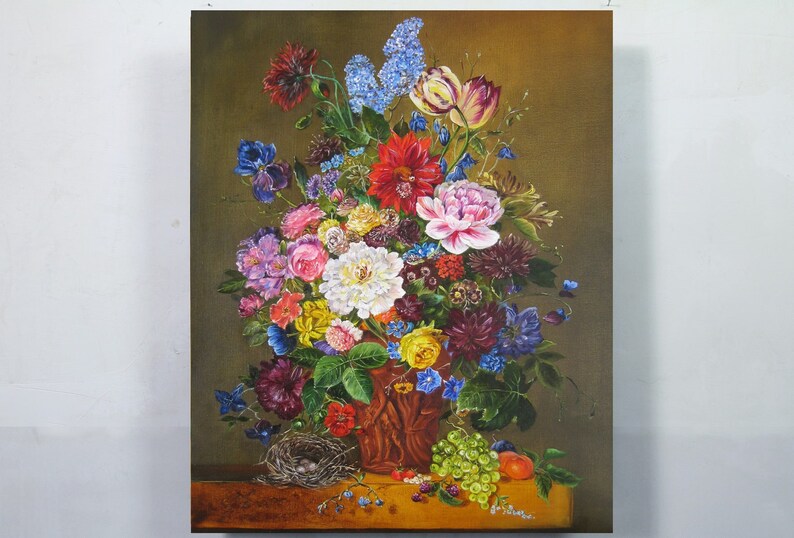 May include: A still life painting of a vase filled with a variety of colorful flowers, including roses, tulips, and lilies. The vase is brown and has a rustic texture. There is a bird's nest with eggs at the bottom of the painting, along with grapes and an apple.
