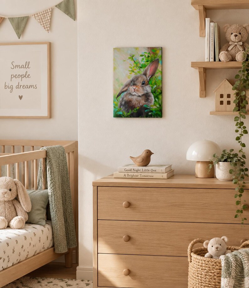 May include: A rectangular wall art print featuring a painting of a brown rabbit nestled among vibrant green foliage. The artwork displays soft brushstrokes and natural tones, depicting the rabbit with alert ears and a gentle expression in a garden.