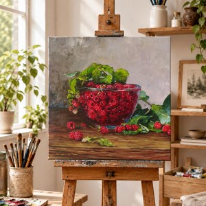 May include: A square oil painting on canvas depicting a clear glass bowl filled with vibrant red raspberries. The bowl sits on a dark wooden surface, surrounded by green leaves and scattered berries, set against a neutral gray background.