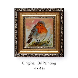 May include: An original oil painting of a robin bird with a red breast and grey wings, set in a decorative gold-toned frame with ornate detailing. The artwork measures 4 x 4 inches and features a soft, painterly background with green foliage.