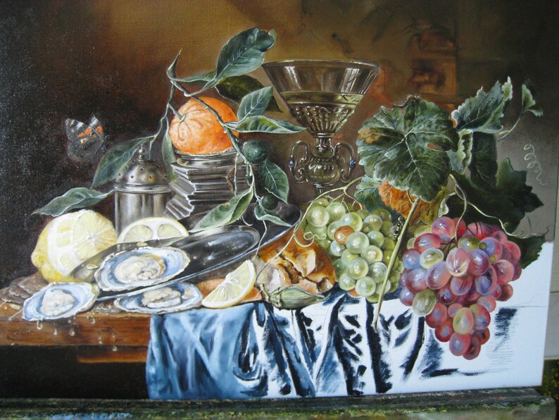 May include: An oil painting still life featuring a silver platter with open oysters, a lemon, a glass goblet, a stack of books topped with an orange, green and red grapes, and a blue cloth draped over a wooden table with a butterfly nearby.