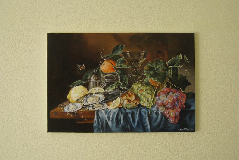 May include: A still life oil painting on canvas depicting a dark scene with oysters on a silver platter, a lemon, an orange with green leaves, a glass goblet, and clusters of green and red grapes resting on a blue draped cloth surface.