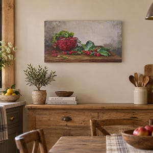 May include: A rectangular canvas wall art print featuring a still life painting of a glass bowl filled with bright red raspberries and green leaves resting on a dark wooden surface against a neutral gray background.
