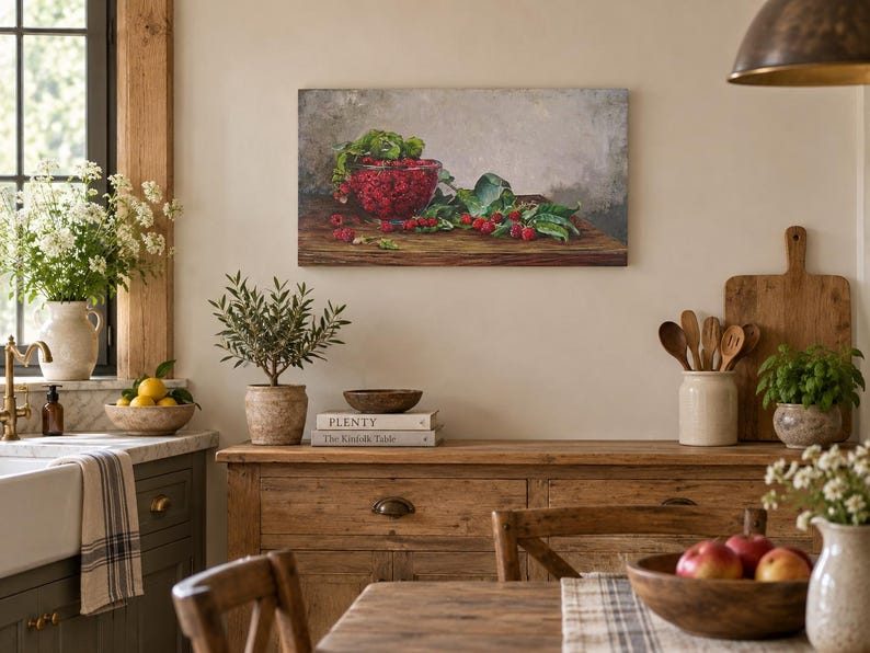 May include: A rectangular canvas wall art print featuring a still life painting of a glass bowl filled with bright red raspberries and green leaves resting on a dark wooden surface against a neutral gray background.