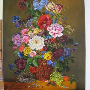 May include: A still life painting of a bouquet of colorful flowers in a brown ceramic vase. The flowers include red, pink, white, yellow, blue, and purple blooms. The vase is decorated with a brown and white pattern. There are green grapes and a peach on the table below the vase.
