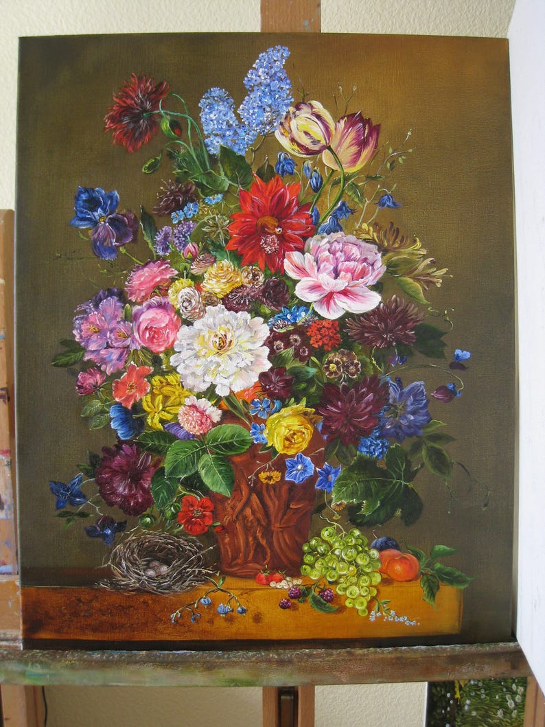 May include: A still life painting of a bouquet of colorful flowers in a brown ceramic vase. The flowers include red, pink, white, yellow, blue, and purple blooms. The vase is decorated with a brown and white pattern. There are green grapes and a peach on the table below the vase.