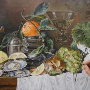 May include: A still life oil painting in progress featuring a bright orange, green grapes, sliced lemons, oysters on a silver platter, a metal shaker, and an ornate glass goblet. A small butterfly is visible on the left side of the composition.