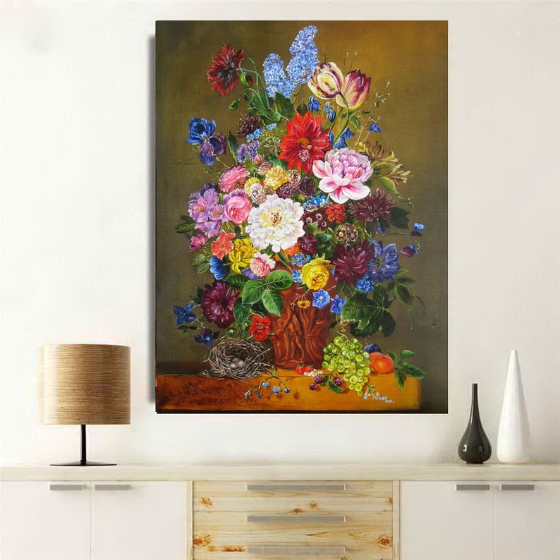 May include: A still life painting of a bouquet of colorful flowers in a brown vase. The flowers include roses, lilies, and other blooms. The vase is sitting on a table with a bird's nest and grapes.