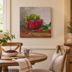 May include: A square canvas wall art print depicting a glass bowl filled with bright red raspberries and green leaves resting on a dark wooden surface. The painting features a neutral gray background and highlights the vibrant texture of the fruit.