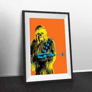 May include: Framed pop art print featuring a yellow and black Chewbacca character on an orange background. The character is holding a blue weapon and wearing a blue bandolier. The print is in a black frame.