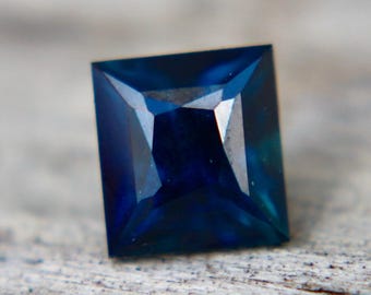 Discover this 0.97 carat Natural Greenish Blue Peacock Sapphire from Madagascar. Unheated, untreated, VVS clarity, princess cut.
