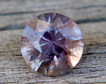Ceylon Purplish-Brown Sapphire: 0.77 Carat Round Cut Gemstone