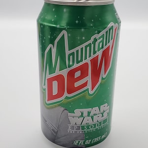 May include: A green and silver 12-ounce can of Mountain Dew soda with a Star Wars Episode I: The Phantom Menace design. The can features a silver image of Anakin Skywalker.