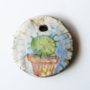 Blue cactus round ceramic medallion, summer illustration raku pendant, blue green and brown, handmade, unique piece, handicrafts, mexico