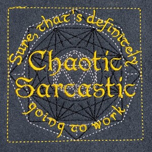 May include: Dark gray fabric with embroidered text in yellow and white. The text reads "Sure that's definitely Chaotic Sarcastic going to work" in a decorative font, surrounded by geometric shapes and a yellow border.