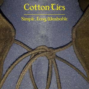 May include: Close-up of black cotton ties tied together on a blue fabric background. The text "Cotton Ties" and "Simple, Easy, Washable" is printed above the ties.