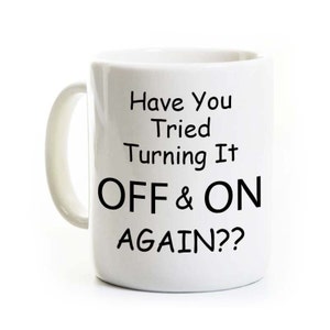 May include: White ceramic coffee mug with black text that reads "Have You Tried Turning It OFF & ON AGAIN??"